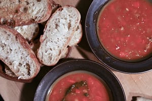 Bowls of soup and buttered bread.