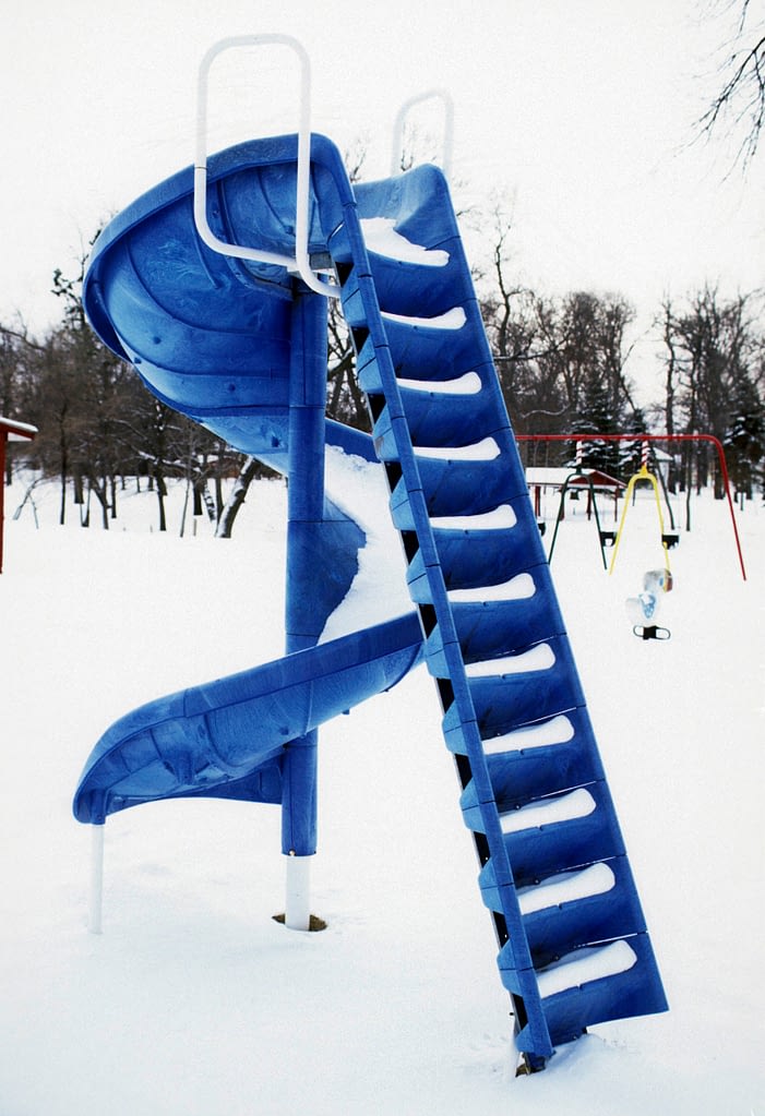 blue playground slide in the snow