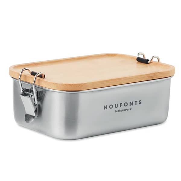 Lunchbox with logo SONABOX Stainless steel lunch box with logo with side closure buckles and bamboo lid. Capacity: 750 ml. Depending on the surface we can use embroidery, engraving, 360° imprint or screen print.