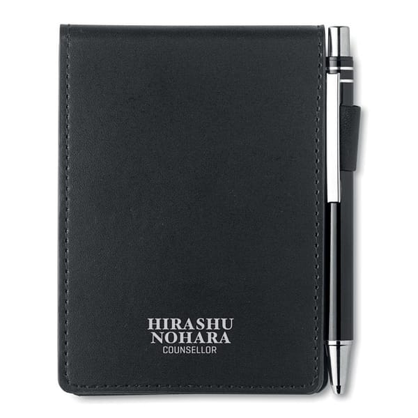 Notepad with logo CAM A7 A7 notepad with logo and matching pen. PU pouch with pen holder. 60 plain pre-perforated sheets. Matching metal push button ball pen. Blue ink. Dimensions: 11,5X9,5X1,2 CM PMS Colour: BLACK.  Main material: PU paper Depending on the surface we can use embroidery, engraving, 360° imprint or screen print.