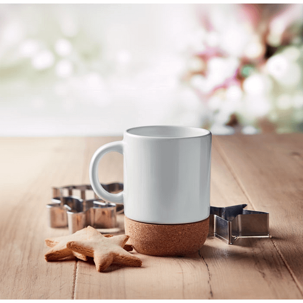 Mug with logo SUBCORK Ceramic mug with logo with special coating for sublimation print and cork base detail. Capacity: 300 ml A stylish cup with a cork base for a natural look. Start the day good and drink your favourite morning coffee of tea in this mug. Each mug is packed individually in a white carton box. Available color: White Dimensions: Ã˜8,3X11 CM Height: 11 cm Diameter: 8.3 cm Volume: 1.25 cdm3 Gross Weight: 0.4 kg Net Weight: 0.336 kg Magnus Business Gifts is your partner for merchandising, gadgets or unique business gifts since 1967. Certified with Ecovadis gold!
