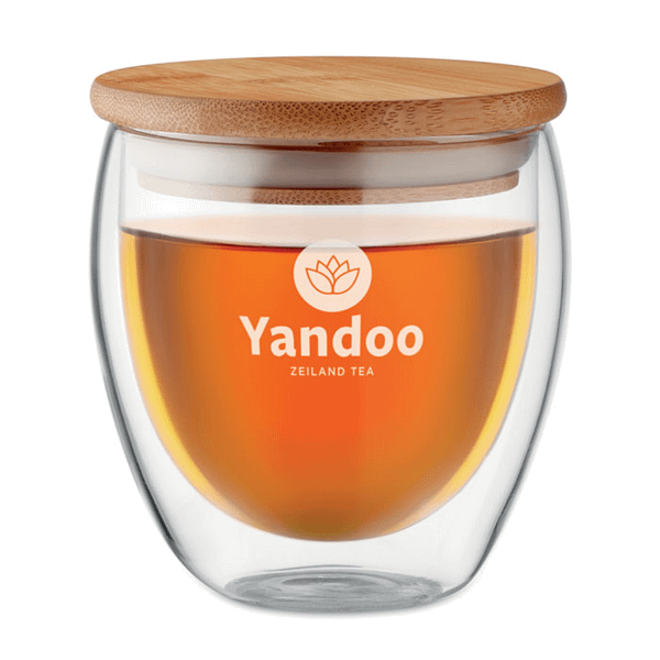 Mug with logo TIRANA SMALL Double wall high borosilicate glass with bamboo lid with silicone ring. Capacity 250 ml. Bamboo is a natural product, there may be slight variations in colour and size per item, which can affect the final decoration outcome. Available color: Transparent Dimensions: 8.5X10.3CM Width: 10.3 cm Length: 8.5 cm Volume: 1.57 cdm3 Gross Weight: 0.267 kg Net Weight: 0.181 kg Magnus Business Gifts is your partner for merchandising, gadgets or unique business gifts since 1967. Certified with Ecovadis gold!