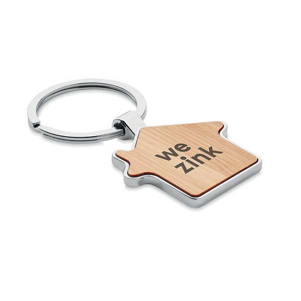 Key ring with logo BURNIE Key ring with logo house shaped in zinc alloy with bamboo front. Bamboo is a natural product, there may be slight variations in color and size per item,                                                                                                                                                                                            which can affect the final decoration outcome. Available color: Wood Dimensions: 7X4X0,3CM Width: 4 cm Length: 7 cm Height: 0.3 cm Volume: 0.087 cdm3 Gross Weight: 0.028 kg Net Weight: 0.018 kg Depending on the surface we can use embroidery, engraving, 360° imprint or screen print.