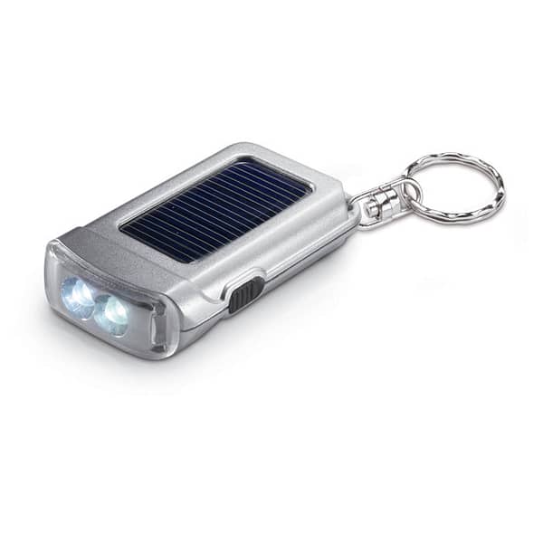 Key ring with logo torch solar RINGAL Key ring with logo in satin silver. Torch key ring with 2 white LED bulbs powered by solar panel. Available color: Matt Silver Dimensions: 6,5X3,9X1,5 CM Width: 3.9 cm Length: 6.5 cm Height: 1.5 cm Volume: 0.132 cdm3 Gross Weight: 0.035 kg Net Weight: 0.026 kg Depending on the surface we can use embroidery, engraving, 360° imprint or screen print.