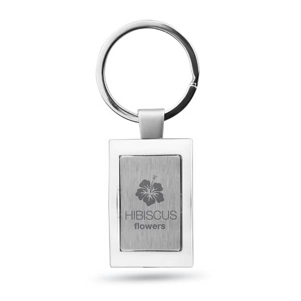 Gadget with logo Key ring HARROBS Metal rectangular key ring with logo. Individually packed in a gift box. Available color: Shiny Silver Dimensions: 8X3,5X0,5 CM Width: 3.5 cm Length: 8 cm Height: 0.5 cm Volume: 0.11 cdm3 Gross Weight: 0.039 kg Net Weight: 0.03 kg Magnus Business Gifts is your partner for merchandising, gadgets or unique business gifts since 1967. Certified with Ecovadis gold!