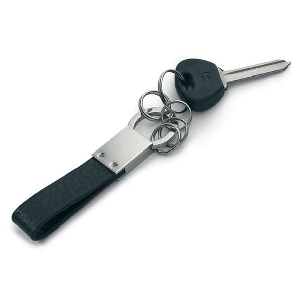 Gadget with logo Key ring GENUINE Multi-rings key ring with logo with PU leather strap. Available color: Black Dimensions: 11X2X0,5 CM Width: 2 cm Length: 11 cm Height: 0.5 cm Volume: 0.11 cdm3 Gross Weight: 0.035 kg Net Weight: 0.026 kg Magnus Business Gifts is your partner for merchandising, gadgets or unique business gifts since 1967. Certified with Ecovadis gold!