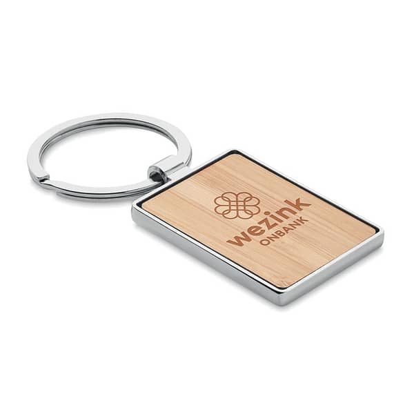 Key ring with logo BENDIGO Key ring with logo rectangular shaped in zinc alloy with bamboo front. Bamboo is a natural product, there may be slight variations in color and size per item,                                                                                                                                                                                      which can affect the final decoration outcome. Available color: Wood Dimensions: 8X3,2X0,4CM Width: 3.2 cm Length: 8 cm Height: 0.4 cm Volume: 0.085 cdm3 Gross Weight: 0.036 kg Net Weight: 0.03 kg Depending on the surface we can use embroidery, engraving, 360° imprint or screen print.