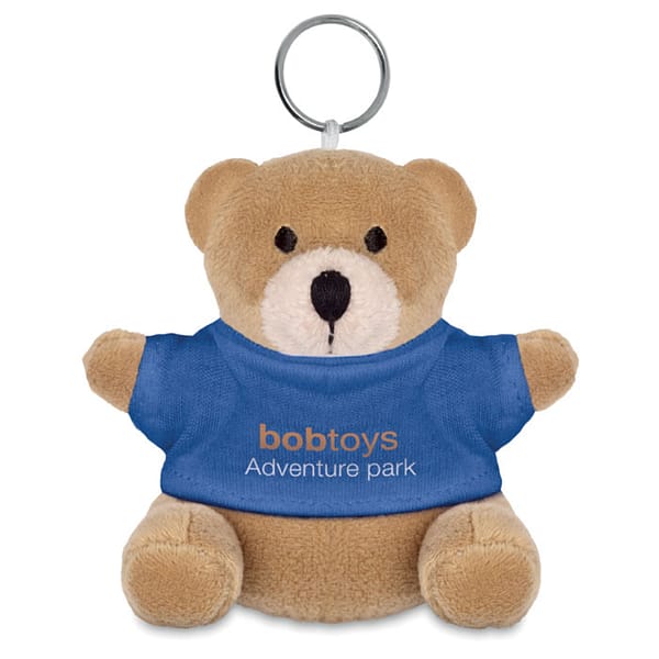 Key ring with logo Teddy bear NIL Teddy bear plush key ring. 100% cotton t-shirt for logo imprint. Available color: Blue, Red, White Dimensions: 5X9 CMWidth: 9 cmLength: 5 cmVolume: 0.262 cdm3Gross Weight: 0.021 kgNet Weight: 0.018 kg Magnus Business Gifts is your partner for merchandising, gadgets or unique business gifts since 1967. Certified with Ecovadis gold!