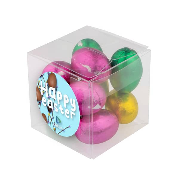 Small Easter Chocolate Box With logo Introducing our captivating Easter treat: the Transparent Cube with Easter Chocolate! Designed to delight, this charming cube showcases a full-color sticker on the front, adding a vibrant touch to its transparent allure. Inside, discover a delectable assortment of 65 grams of chocolate Easter eggs, each adorned in assorted colors for a visually stunning and flavorful experience. Magnus Business Gifts is your partner for merchandising, gadgets or unique business gifts since 1967. Certified with Ecovadis gold!