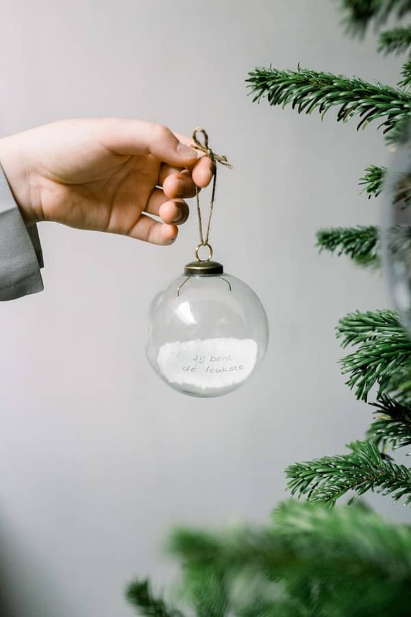 A special Christmas ball with logo message inside can be a wonderful and personalized gift or decoration for the holiday season. This unique ball combines the beauty of traditional ornaments with the element of surprise and sentimentality. This Christmas ball is made of clear translucent glass allowing the paper message inside to be visible. MOQ 250pcs. The paper message is an integral part of this special ornament. You can customize the message with a heartfelt note, a favorite quote,                                                                                                            a special memory, or a wish for the recipient. Write or print the message on a durable, lightweight paper that can easily be rolled or folded to fit inside the ball. The beauty of this Christmas ball lies not only in its visual appeal but also in the heartfelt message contained within. It's a delightful way to show someone you care and to add a touch of personalized magic to their holiday celebrations. Magnus Business Gifts is your partner for merchandising, gadgets or unique business gifts since 1967. Certified with Ecovadis gold!