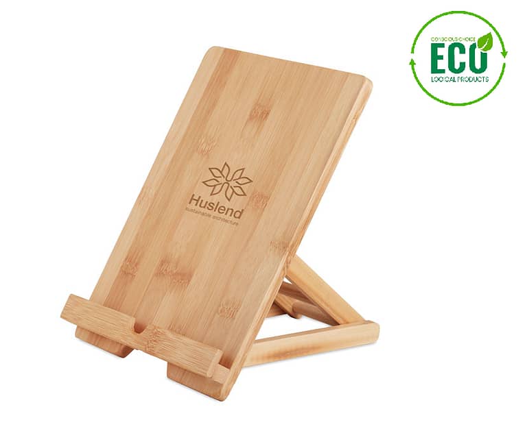 Gadget with logo tablet stand TUANUI Gadget with logo, foldable tablet or smartphone stand in bamboo. The opening in the bottom of the stand allows for charging or earphone cables to pass through. Bamboo is a natural product, there may be slight variations in color and size per item, which can affect the final decoration outcome. Available color: Wood Dimensions: 22,3X16,8X4,2CM Width: 16.8 cm Length: 22.3 cm Height: 4.2 cm Volume: 2.133 cdm3 Gross Weight: 0.383 kg Net Weight: 0.296 kg Depending on the surface we can use embroidery, engraving, 360Â° imprint or screen print.