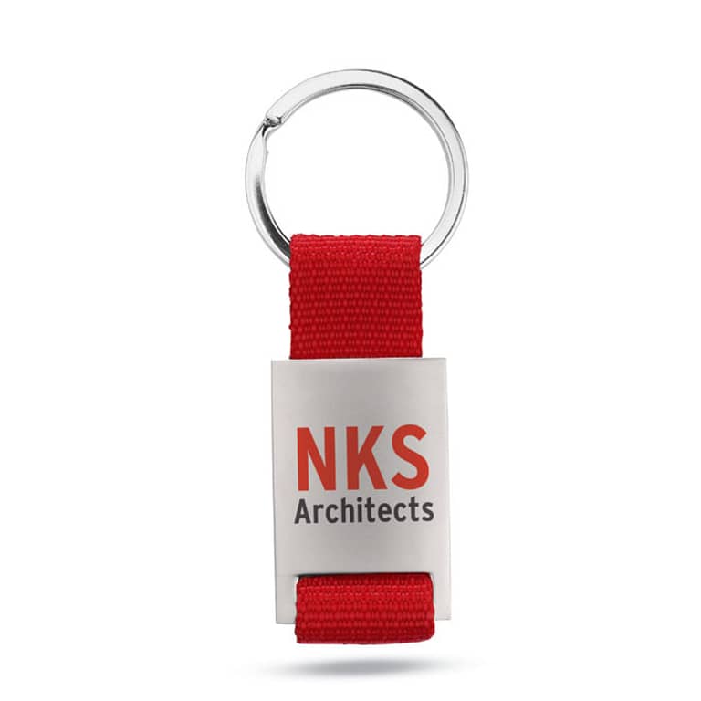 Gadget with logo Key ring TECH Metal rectangular key ring  with logo with coloured polyester webbing. Individually packed in a carton gift box. Available color: Red, Blue, Black Dimensions: 9X3,5X0,8 CM Width: 3.5 cm Length: 9 cm Height: 0.8 cm Volume: 0.11 cdm3 Gross Weight: 0.034 kg Net Weight: 0.026 kg Magnus Business Gifts is your partner for merchandising, gadgets or unique business gifts since 1967. Certified with Ecovadis gold!